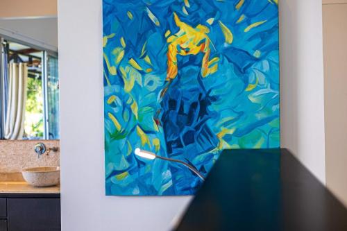 a painting on a wall next to a table at Ocean View Villa With Pool and Spectacular Sunsets in Ballena