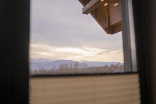a view of the mountains from a window at Apartament w Cieplicach Prime in Jelenia Góra