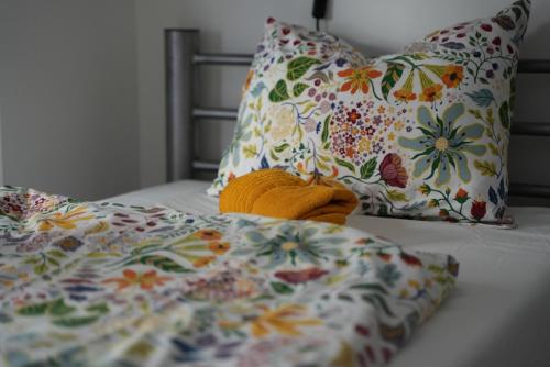 a bed with a yellow blanket and pillows at Center Hostel and Guest House in Budapest
