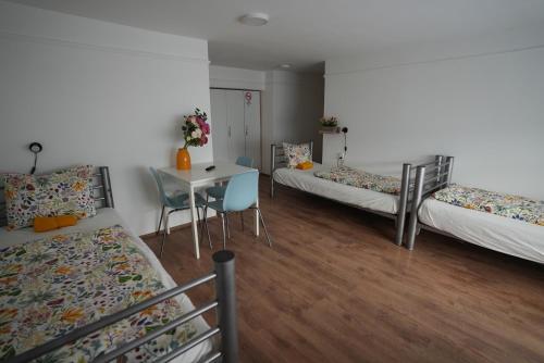 A bed or beds in a room at Center Hostel and Guest House