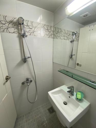 a white bathroom with a sink and a shower at Sweet House Incheon in Incheon