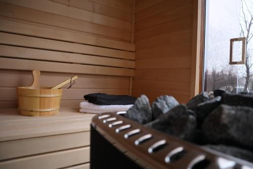 a sauna with a bucket and towels and a window at Seoska kuca Stojanović in Kladovo