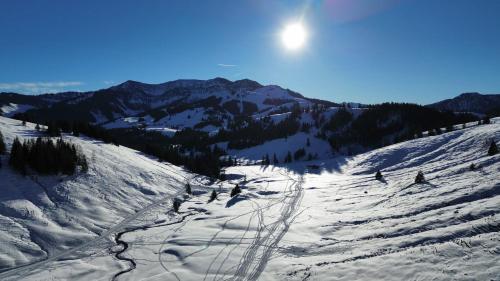 a group of people skiing down a snow covered slope at Landhaus Renata - Wendelstein in Bayrischzell