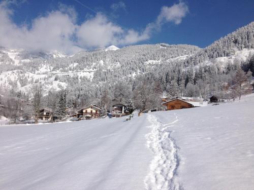 a snow covered road with footprints in the snow at Landhaus Renata - Wendelstein in Bayrischzell