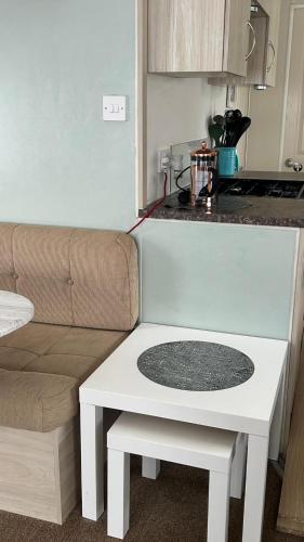 a living room with a white table and a couch at CASALIE at Seasalter Whitstable in Seasalter