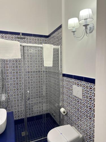 a bathroom with a shower with a toilet and a sink at Queen Suite - Luxury Rooms in Ischia