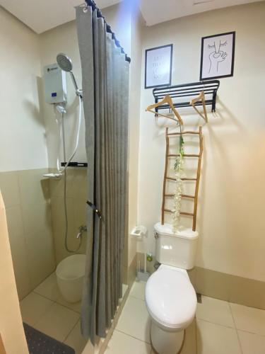 a bathroom with a toilet and a shower at A&A cabin in Manila