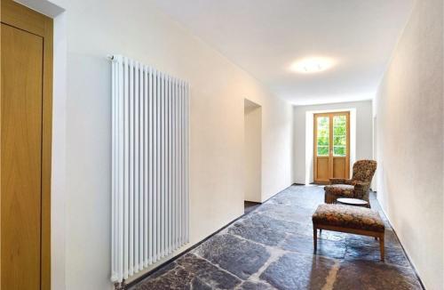 an empty hallway with two chairs and a radiator at Hotel des Alpes in Inden