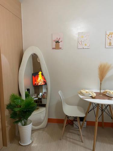 a room with a table and a chair and a mirror at A&A cabin in Manila
