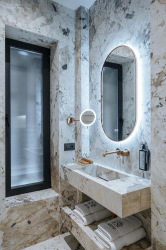 a bathroom with a sink and a mirror at Arctic Boutique Hotel in Korçë