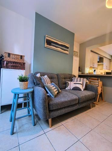 a living room with a couch and a table at Seabreeze Pet friendly 3 bedroom house by the sea in Gorleston-on-Sea