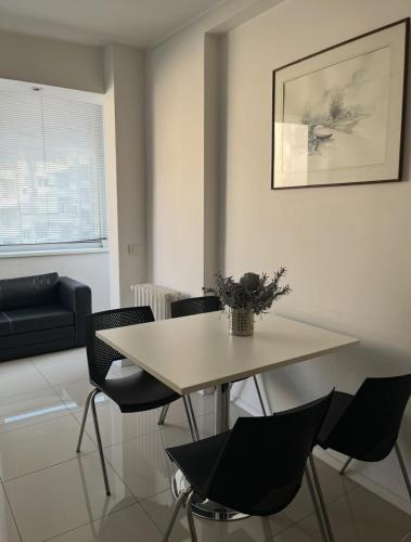 a table and chairs in a living room at ARSS Apartment Skopje Main Square in Skopje