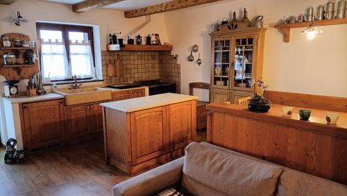 a large kitchen with wooden cabinets and a sink at Baita Compet in Vetriola
