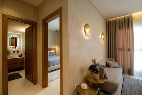 a living room with a couch and a bedroom at CENTAURO Prime Residencies in Volos