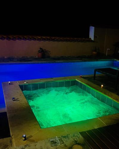 a swimming pool lit up at night at Casa Peak Barichara in Barichara