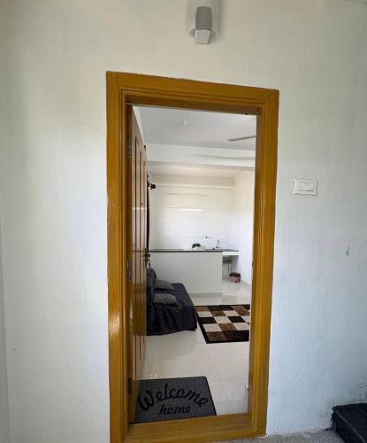 a mirror reflection of a bedroom in a room at TVK Grands 7 - Premium Two Bedroom Apartment in Coimbatore