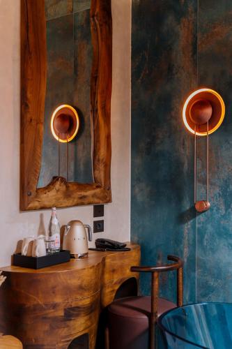 a room with two lights and a mirror on the wall at Arctic Boutique Hotel in Korçë