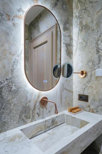 a bathroom with a sink and a mirror at Arctic Boutique Hotel in Korçë