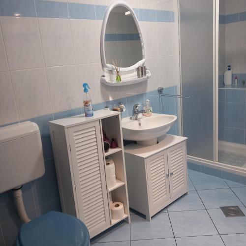 a bathroom with a sink and a mirror at Apartmani Božić-Omišalj in Omišalj