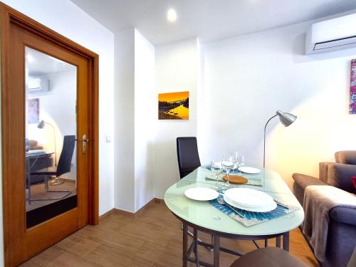 a small living room with a table and a couch at Porto River Sunset 1st in Vila Nova de Gaia