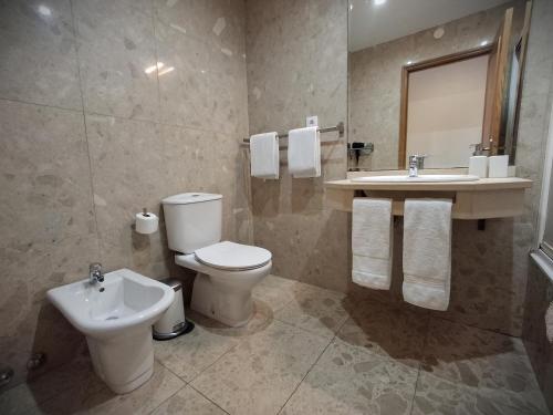a bathroom with a toilet and a sink at Porto River Sunset 1st in Vila Nova de Gaia