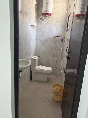 a small bathroom with a toilet and a sink at TVK Grands 7 - Premium Two Bedroom Apartment in Coimbatore