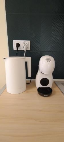 a coffee maker sitting on the floor next to an outlet at Apartament Wenus in Lublin