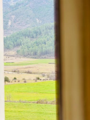 a view of a green field from a window at Kutal Park Inn Hotel in Përmet