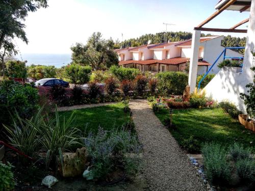 a garden in front of a house at Aelia House Chalkidiki in Fourka