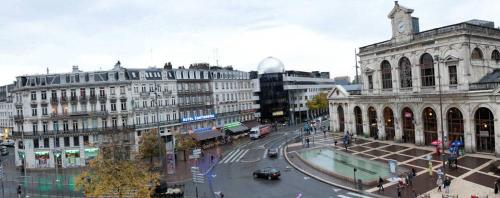 a city with buildings and a street with cars at Hotel De Londres in Lille