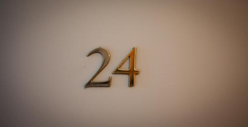 a metal number forty four on a white wall at Hotel De Londres in Lille