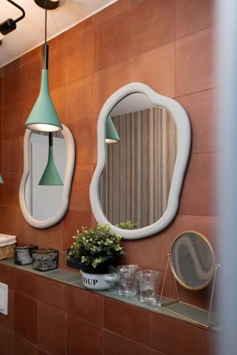a mirror on a wall in a bathroom with a table at Villa Anabella III in Zadar