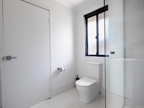 a bathroom with a toilet and a glass shower at Guest Room with Ensuite & Private Entrance by P2 Living in Vasse