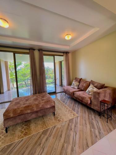 a living room with a couch and a table at Bliss House in Dar es Salaam