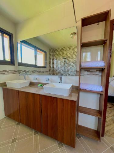 a bathroom with two sinks and a mirror at Bliss House in Dar es Salaam