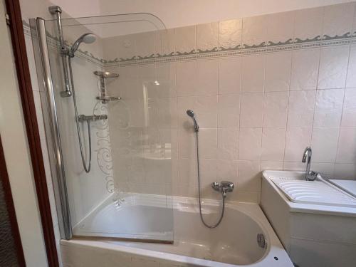 a bathroom with a shower and a tub and a toilet at La finestra sul trenino in Tirano