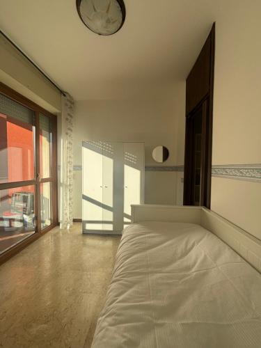 a bedroom with a bed and a clock on the ceiling at La finestra sul trenino in Tirano