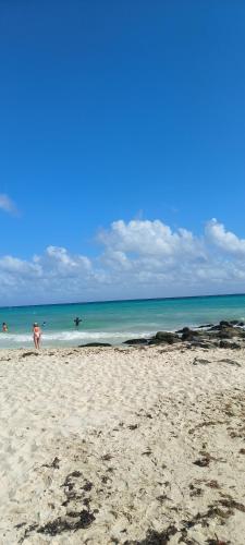 a person standing on a beach with the ocean at Baga Riviera in Playa del Carmen
