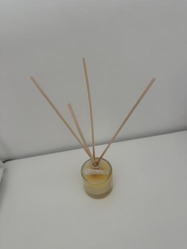 a candle holder hanging from a ceiling with sticks at Queen Suite - Luxury Rooms in Ischia