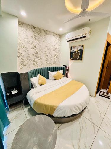 a bedroom with a bed in a room at Hotel Sparsh Inn in Ahmedabad
