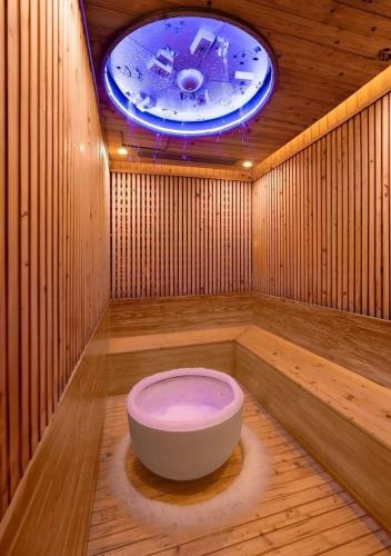 a sauna with a tub in the middle of a room at SP Sky OASIS 27 06 QuynhDao HomeStay in Kim Quan