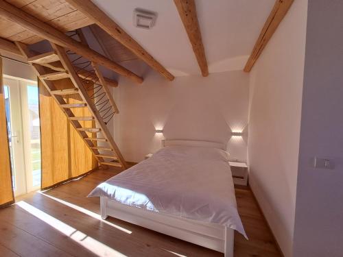 a bedroom with a bed in a room with stairs at Complex Turistic Padurea Mare in Bălţăteşti