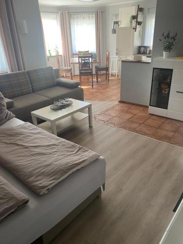 a living room with a couch and a table at Spreewald-Ferienwohnung Jahn in Radensdorf