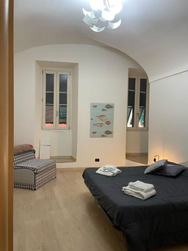 a bedroom with a bed and a chair in it at Casa Luna in Ventimiglia