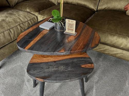 a wooden coffee table on a couch with a plant on it at Aiskew Villa Annex in Bedale