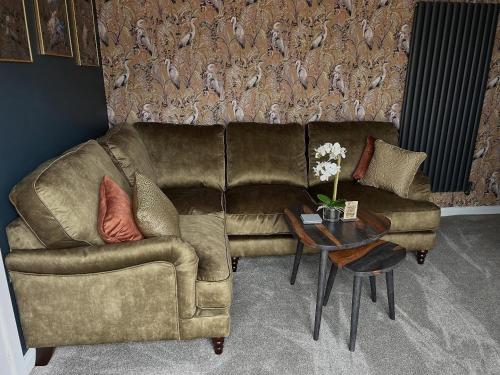 a living room with a couch and a table at Aiskew Villa Annex in Bedale