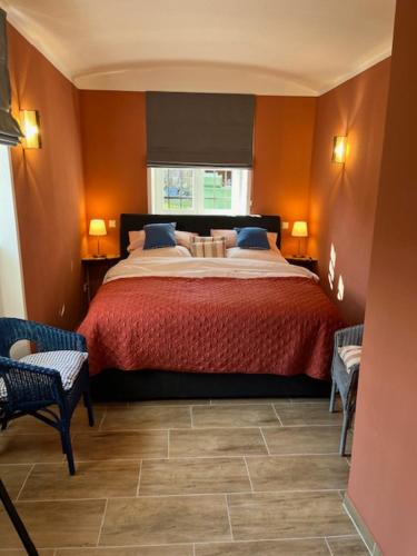 a bedroom with a bed and two chairs and a window at Luxury 1 Bed-Room Flat 65m2 in Görlitz