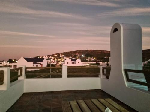 a balcony with a view of a city at Catch and Relax St Helena Bay in West Point