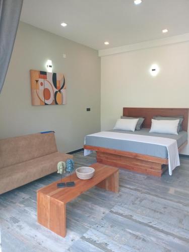 a bedroom with a bed and a couch at The Palms view airport villa in Minuwangoda