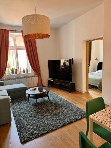 a living room with a couch and a table at Apartament Tuchola in Tuchola